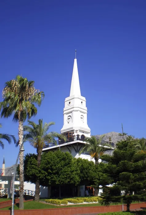 Framed Print : A tall white clock tower surrounded by palm trees