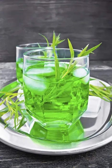 Framed Print : Tarragon lemonade in two glasses with ice on a silver tray on black wooden board background