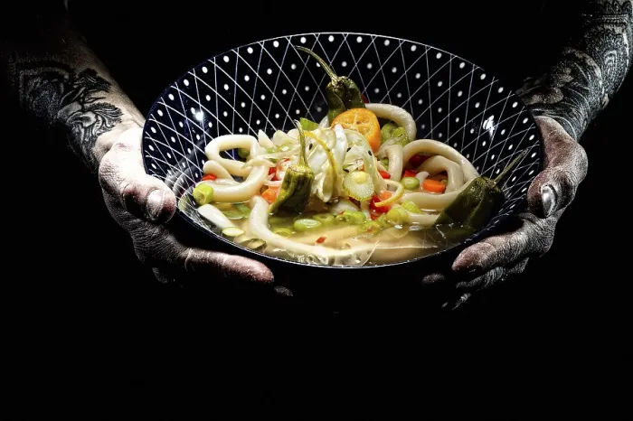 Framed Print : Tattooed hands hold plate with udon bowl Framed Print : Tattooed hands hold plate with udon bowl
