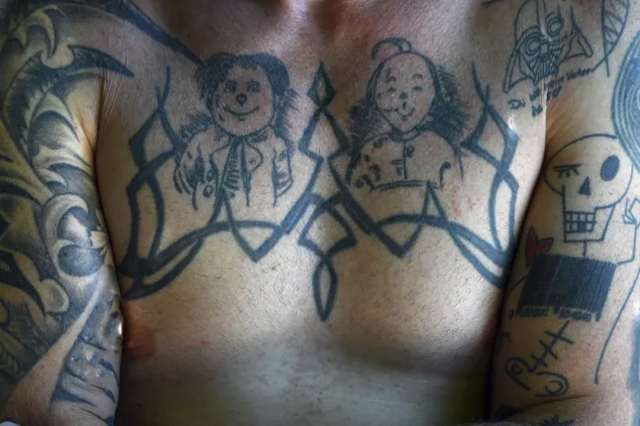 Framed Print : Tattoos Max and Moritz on the chest of a young man Framed Print : Tattoos Max and Moritz on the chest of a young man