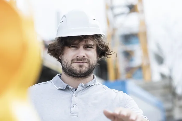 Framed Print : Technician with beard middle aged and wearing polo shirt and helmet outside at work Framed Print : Technician with beard middle aged and wearing polo shirt and helmet outside at work