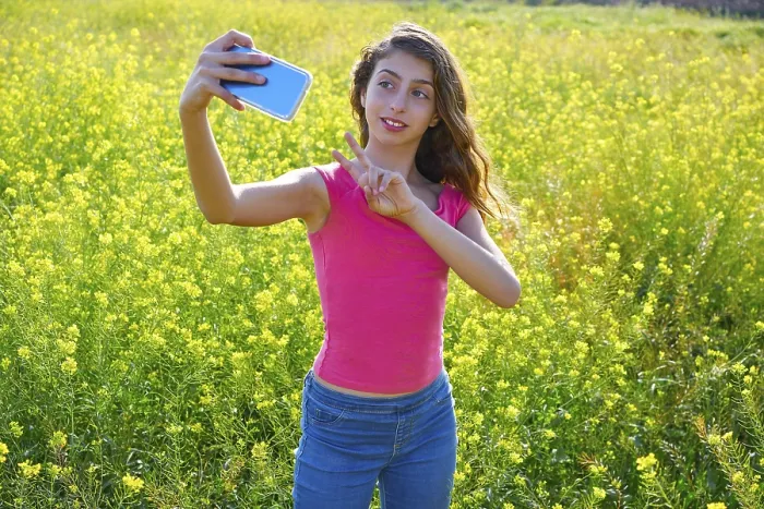 Framed Print : Teen girl serfie video photo in spring meadow gesturing Framed Print : Teen girl serfie video photo in spring meadow gesturing
