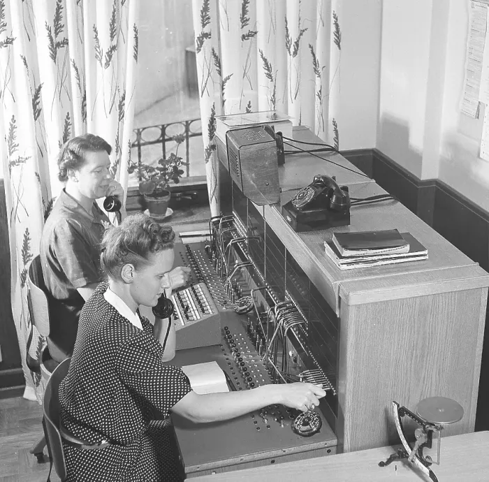 Framed Print : Telephony in the 1950s. Two women working at a telephone switchboard as it's operator