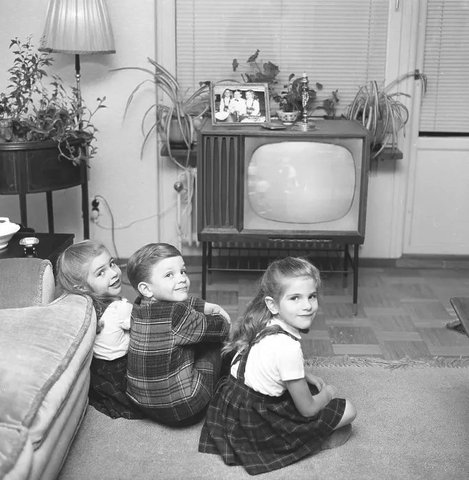 Framed Print : Television in the 1950s. Three children are sitting in front of a television set watching the program Framed Print : Television in the 1950s. Three children are sitting in front of a television set watching the program