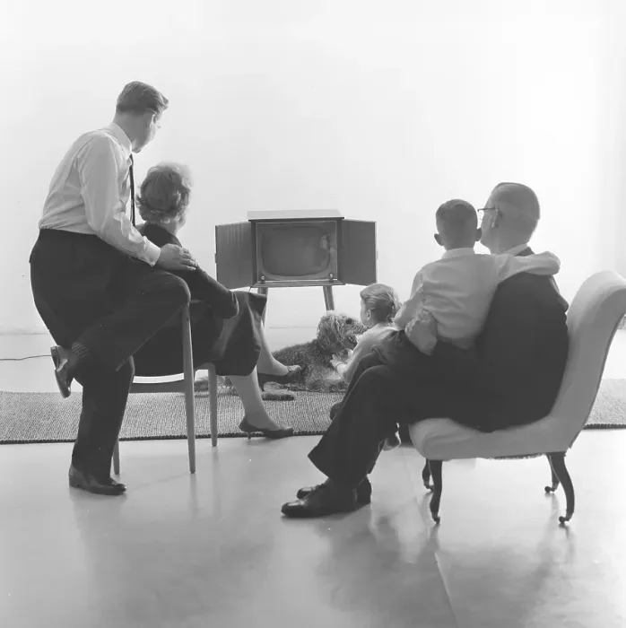 Framed Print : Television in the 1950s. Family in front of a television set and fascinated by the new television medium in March 1959