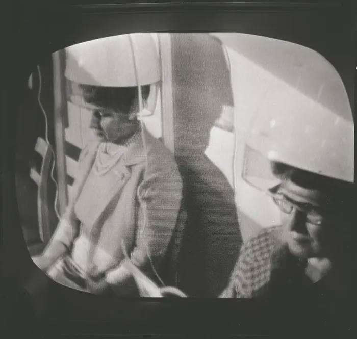 Framed Print : Television in the 1950s. A typical tv screen photographed when a broadcast is on. A scene with woman sitting under drying hoods. ref 4673. Sweden 1958