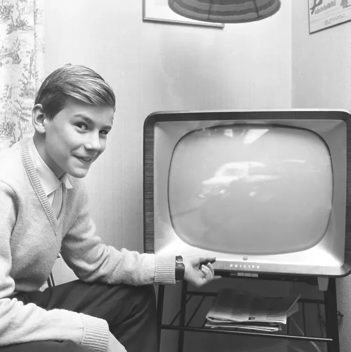 Framed Print : Television in the 1950s. A young man in front of a television set in January 1959
