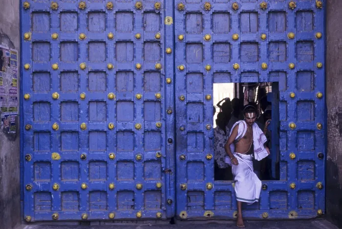 Framed Print : Temple priest crossing the Main door in Varadarajaswamy temple