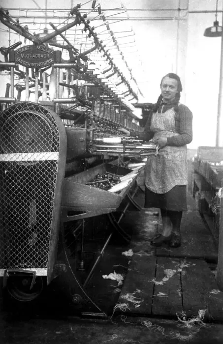 Framed Print : Textile industry, woman works in a spinning mill