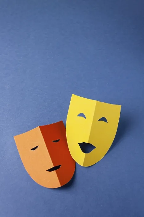 Framed Print : Two theatrical masks made of colored paper on a blue background Framed Print : Two theatrical masks made of colored paper on a blue background