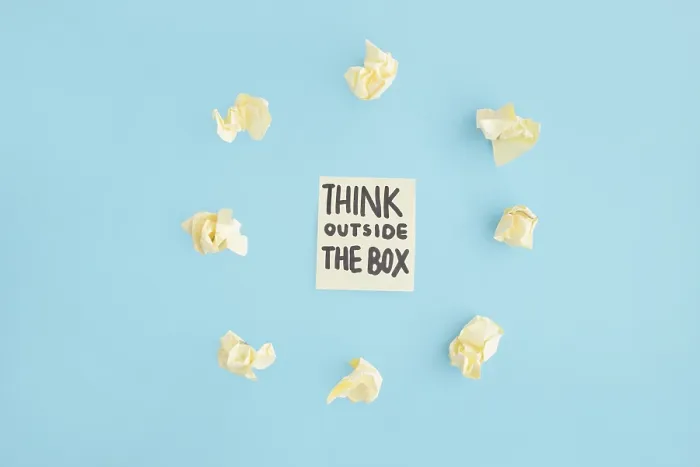 Framed Print : Think outside box text adhesive note surrounded with yellow crumpled paper blue backdrop Framed Print : Think outside box text adhesive note surrounded with yellow crumpled paper blue backdrop