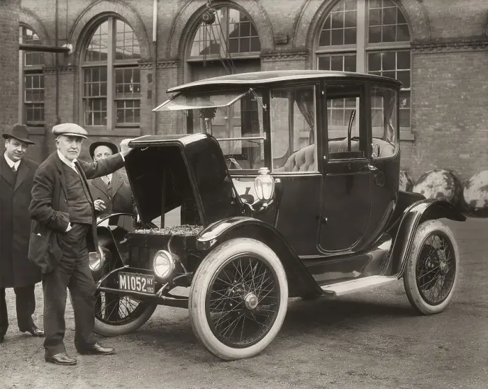 Framed Print : Thomas Alva Edison displaying storage batteries of the power Detroit Electric automobile