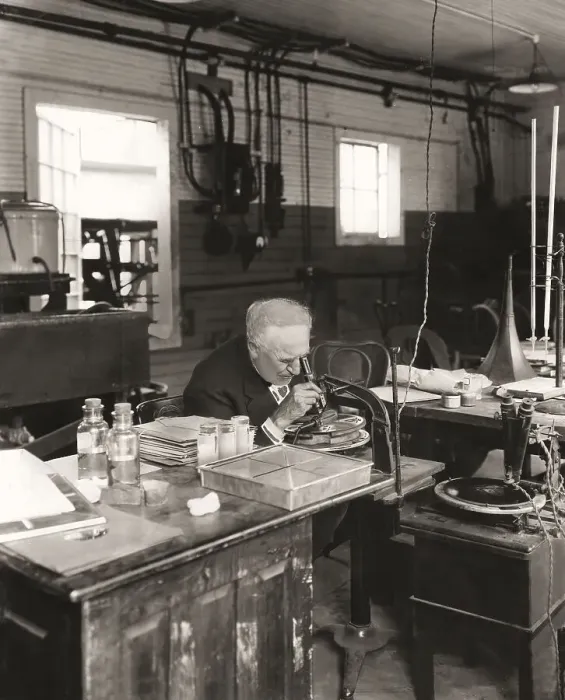 Framed Print : Thomas Alva Edison examining a phonograph disc under a microscope