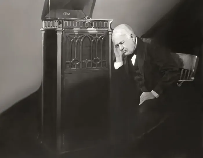Framed Print : Thomas Alva Edison listening to his disc phonograph