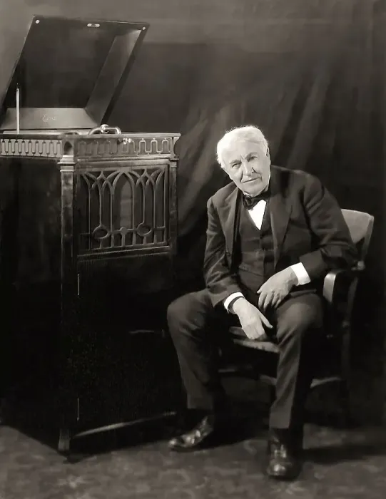 Framed Print : Thomas Alva Edison listening to his disc phonograph