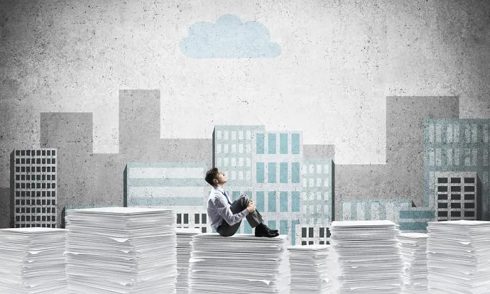 Framed Print : Thoughtful businessman looking away while sitting on pile of documents with drawn cityscape on background
