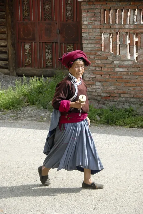 Framed Print : Tibetan Buddhism, ethnology, woman of the Mosu ethnicity dressed in traditional costume swinging a prayer wheel
