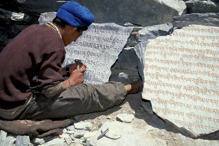 Framed Print : Tibetan Buddhist mantras carved in stone by man