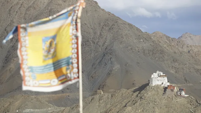 Framed Print : Tibetan Buddhist prayer flag with Namgyal Tsemo Buddhist monastery surrounded by mountains and sky