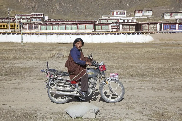 Framed Print : Tibetan man riding motorbike in front of monastery between Sershu Dzong and Sershu Framed Print : Tibetan man riding motorbike in front of monastery between Sershu Dzong and Sershu