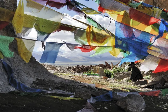 Framed Print : Tibetan pilgrims, prayer flags at the Sacred Stone