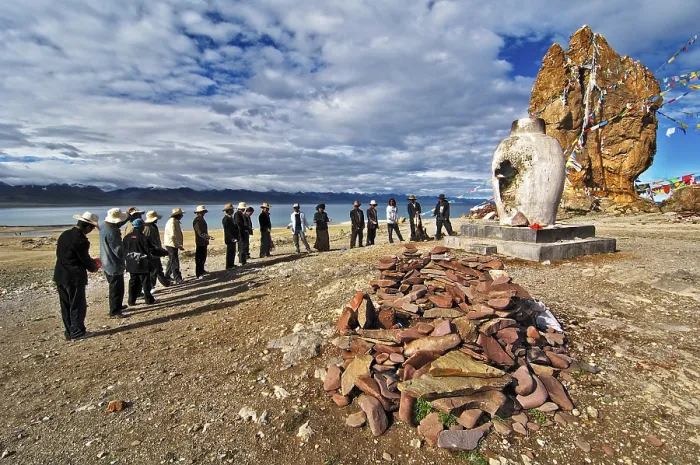 Framed Print : Tibetians at the sacrifice hearth next to the Stone Couple with prayer flags