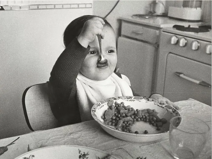 Framed Print : Toddler eats with spoon, between 50s and 60s Framed Print : Toddler eats with spoon, between 50s and 60s