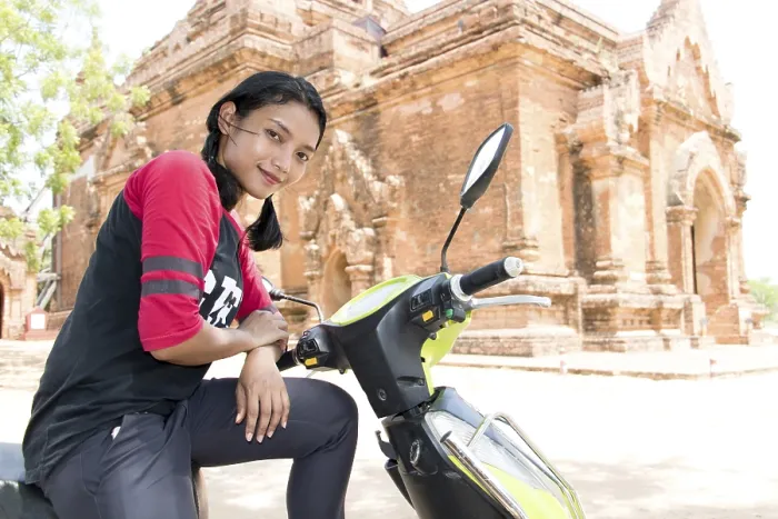 Framed Print : The tourist in Burma sitting on scooter beside historical monuments
