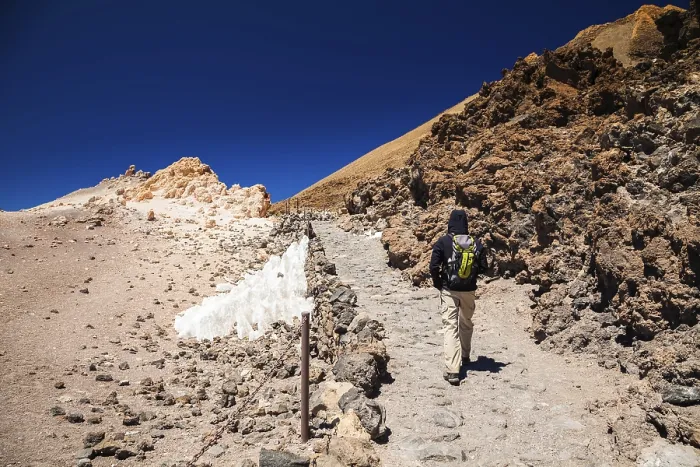 Framed Print : Tourist man with backpack going to the top of the volcano Teide in Tenerife Framed Print : Tourist man with backpack going to the top of the volcano Teide in Tenerife