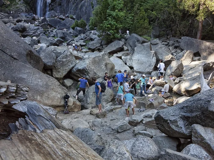 Framed Print : Tourists on boulders, climbing