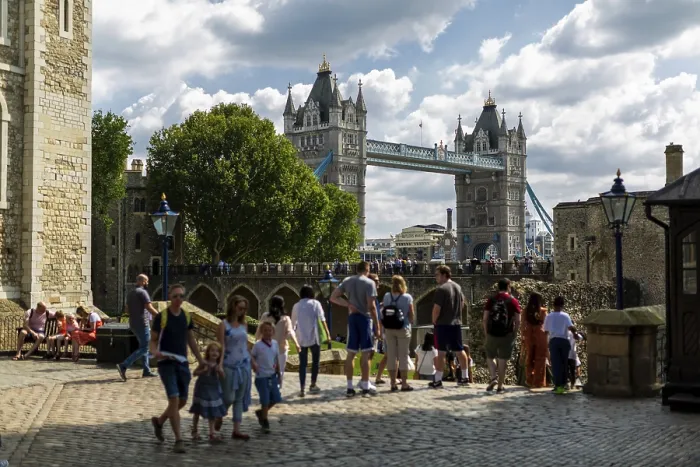 Framed Print : Tourists at promenade with iconic Tower Bridge in background under sunny sky at The Tower of London