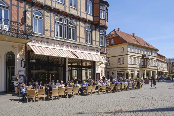 Framed Print : Tourists sitting outside a restaurant on the market square Framed Print : Tourists sitting outside a restaurant on the market square