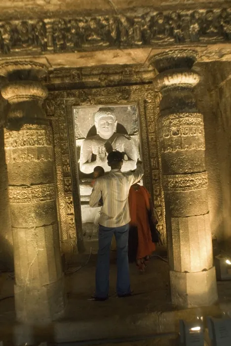 Framed Print : Tourists watching statue of god Buddha in Ajanta caves