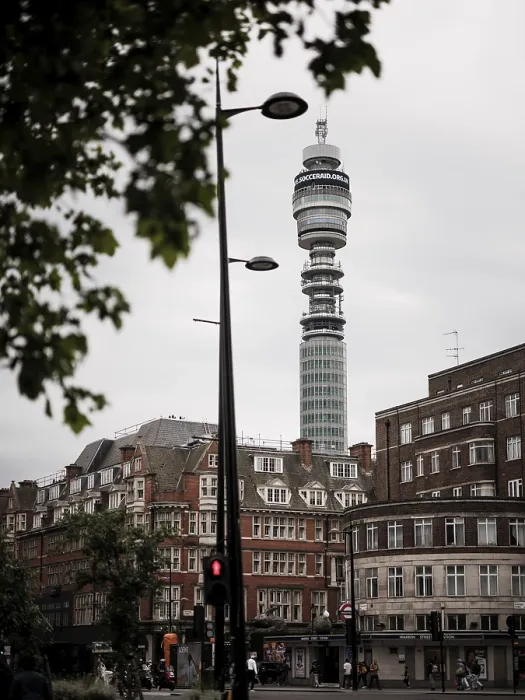 Framed Print : Tower rises above city buildings against a cloudy sky in Greater London