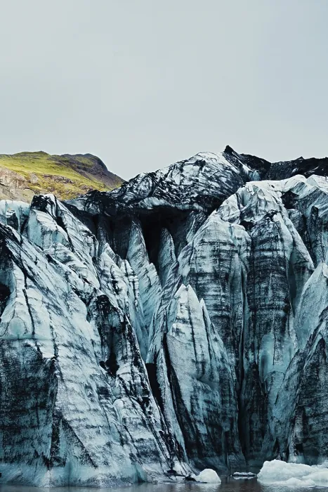 Framed Print : Towering blue glacier peaks with a hint of green vegetation above
