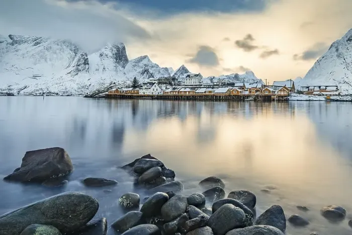 Framed Print : Town and fisherman's cabins or Rorbus in front of snowy mountains Framed Print : Town and fisherman's cabins or Rorbus in front of snowy mountains