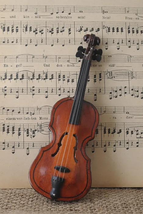 Framed Print : Toy violin in front of music sheet