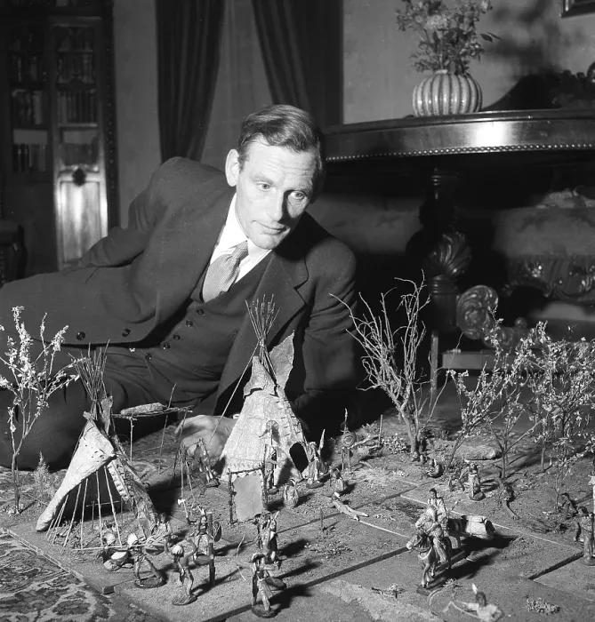 Framed Print : Toys in the 1940s. A man on the floor playing with figures of american indigenous people