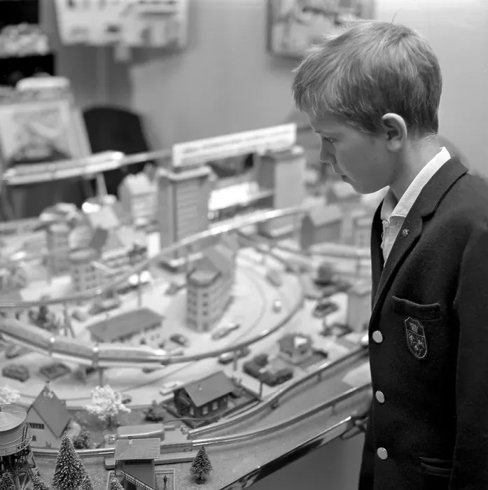 Framed Print : Toys in the 1960s. A boy at a model railway in a store