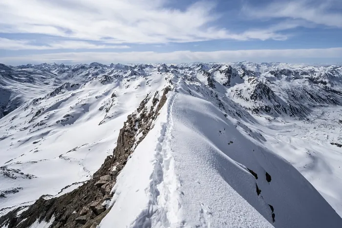 Framed Print : Tracks in the snow on a narrow mountain ridge in winter