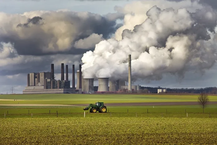 Framed Print : Tractor on a field in front of the steaming lignite-fired power station Frimmersdorf