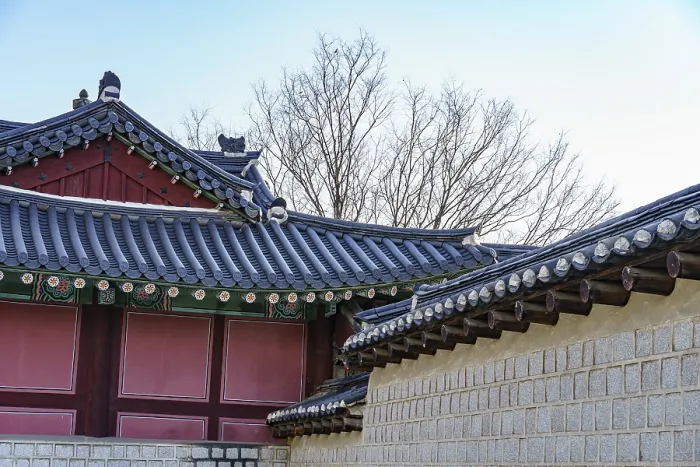 Framed Print : Traditional building architecture with tiled roofs and tree backdrop