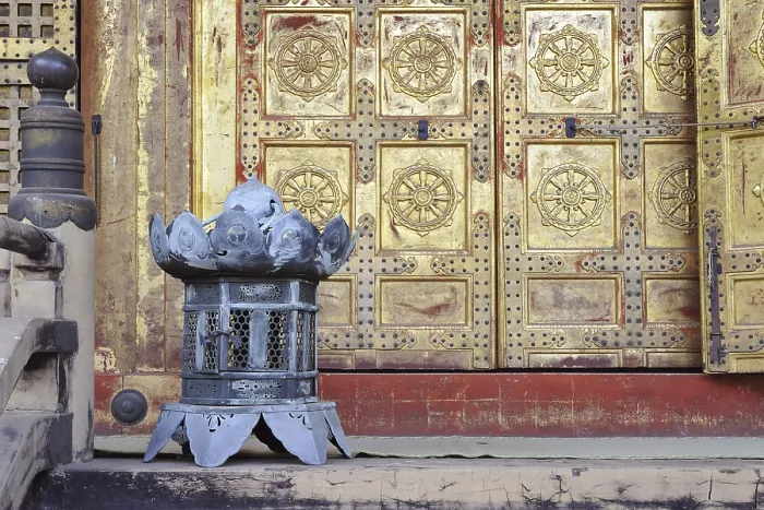 Framed Print : Traditional copper lantern close to scenic doors of oriental Buddhist temple
