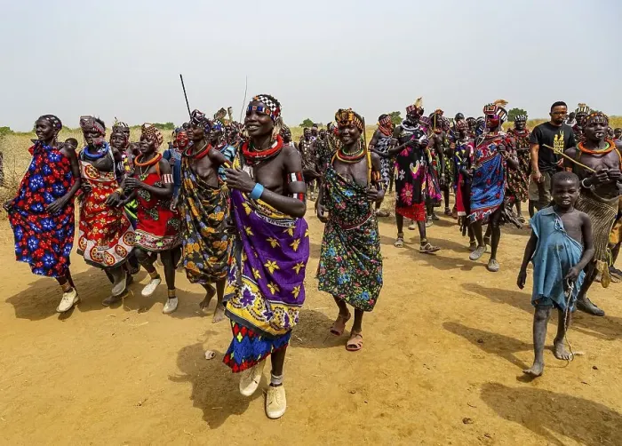Framed Print : Traditional dressed women of the Jiye tribe dancing and singing