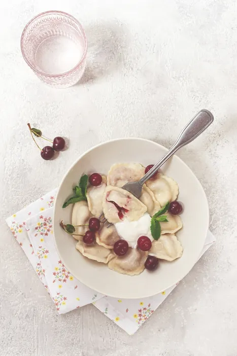 Framed Print : Traditional dumplings with cherries and yogurt