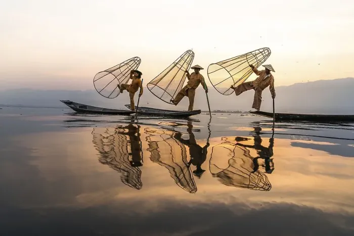 Framed Print : Three traditional fishermen pose standing on their small boats Framed Print : Three traditional fishermen pose standing on their small boats