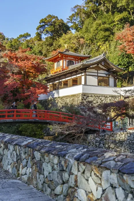 Framed Print : A traditional Japanese temple with red bridge and autumn foliage in a natural setting