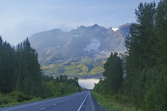 Framed Print : Traffic-free road leads as grades towards rugged mountains