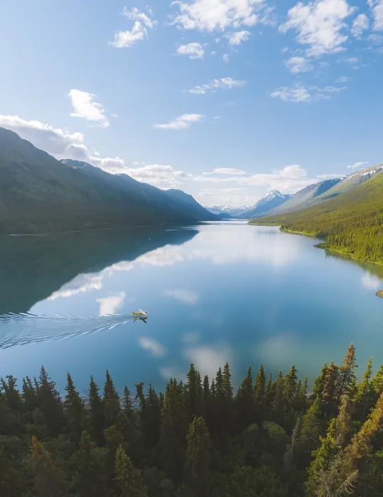 Framed Print : A tranquil lake reflecting the surrounding mountains and forest