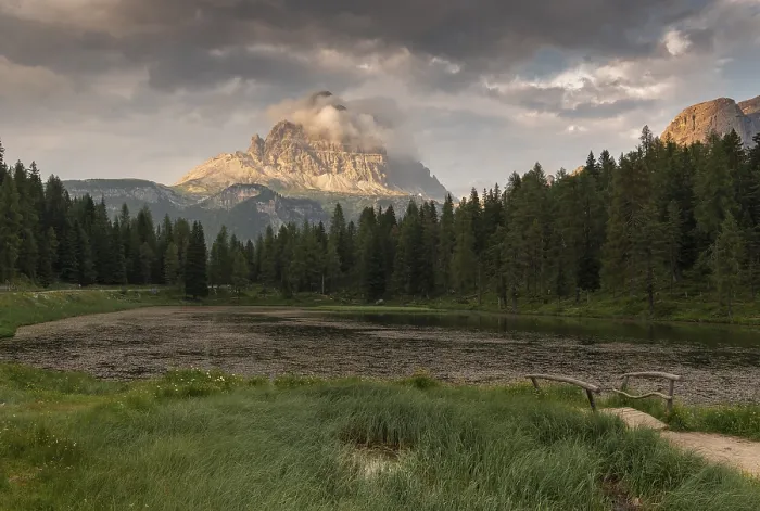Framed Print : A tranquil scene with a mountain and a forest reflected in a calm lake (Lago Antorno) at sunset with some clouds